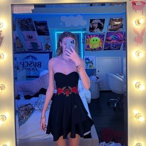 strapless black flowy dress with red flowers